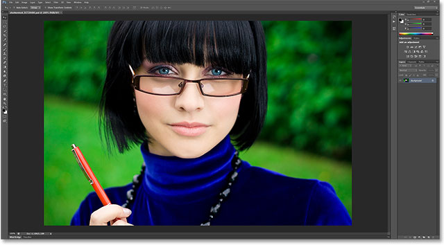 young thinking woman in glasses with pen. Image licensed from Shutterstock by Photoshop Essentials.com