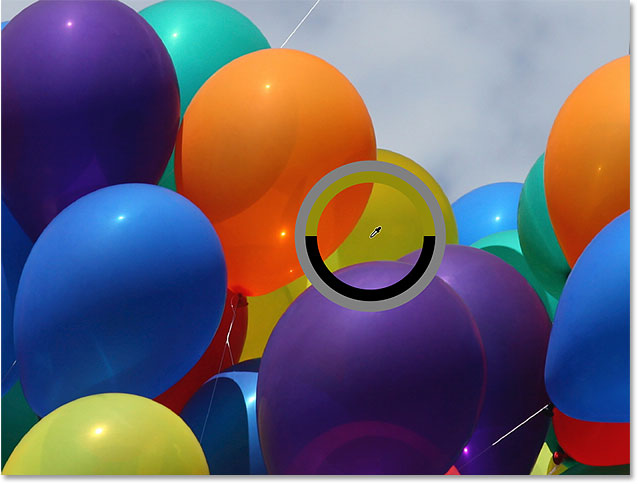 Sampling a color from one of the balloons in the photo. Image © 2016 Photoshop Essentials.com