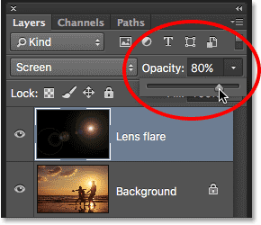 Lowering the opacity of the lens flare layer. 