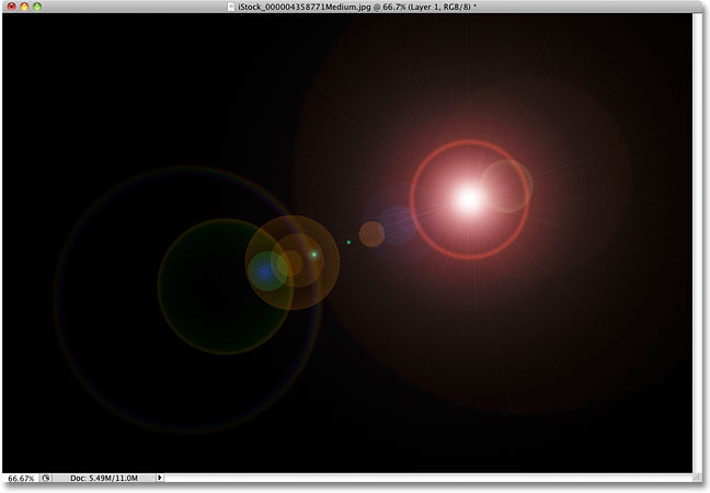 The lens flare has been applied to the solid black layer.